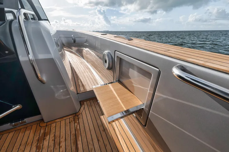  Yacht Photos Pics Pardo Yachts 43 (2022) deck with wooden flooring and foldable table, ocean view.