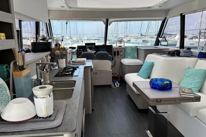  Yacht Photos Pics Luxurious interior of 2025 Fountaine Pajot MY4.S yacht with modern kitchen and seating area.