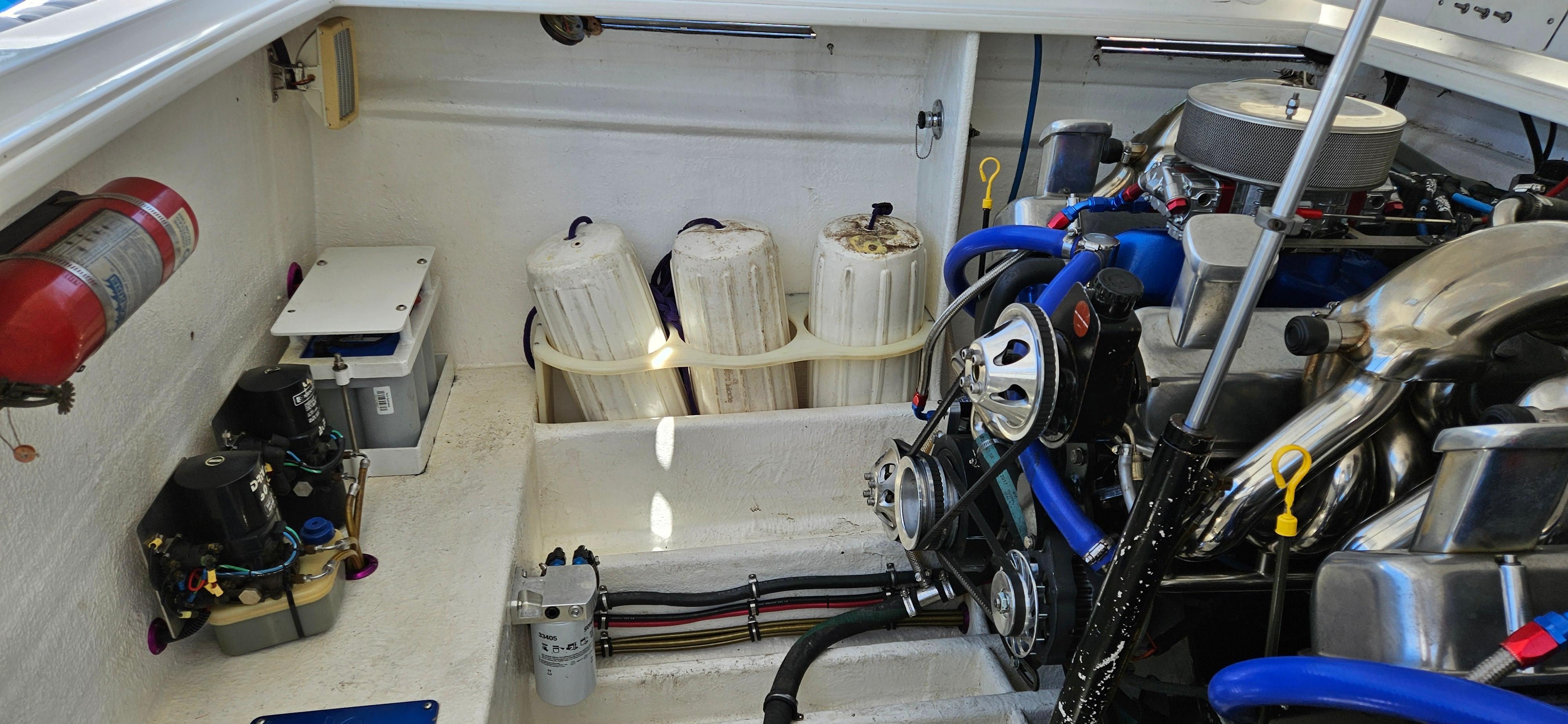 Engine compartment of a 1997 Outerlimits 37 Stiletto boat with visible components.