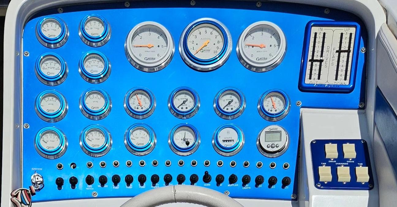 Dashboard of a 1997 Outerlimits 37 Stiletto boat with various gauges and controls.