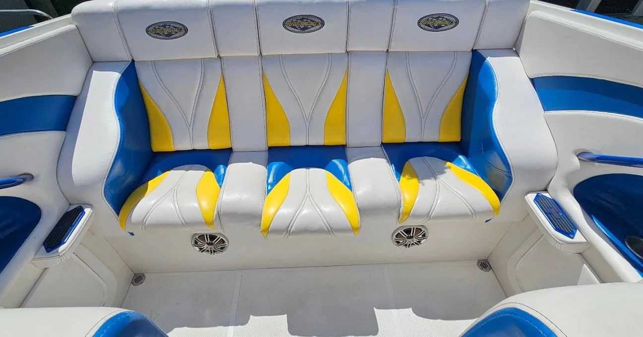 1997 Outerlimits 37 Stiletto boat interior with blue, yellow, and white seating.