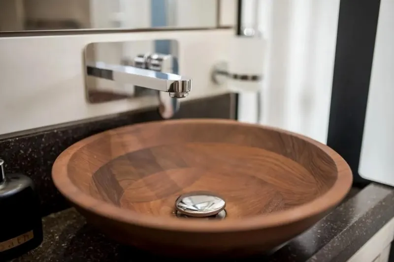  Yacht Photos Pics Wooden sink and modern faucet in 2016 Jeanneau 64 yacht bathroom.