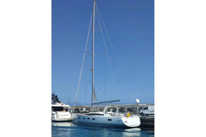  Yacht Photos Pics 2016 Jeanneau 64 sailboat docked in a marina under clear blue skies.
