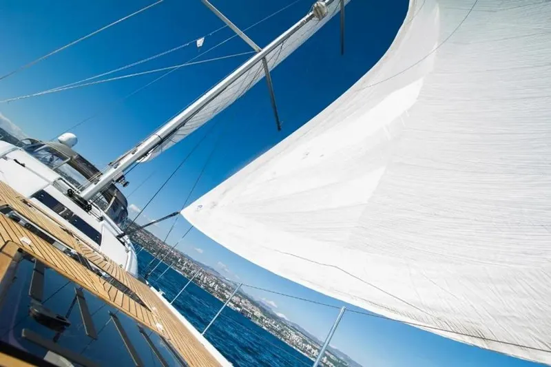 Yacht Photos Pics Sailing on a 2016 Jeanneau 64 yacht with white sails and blue ocean backdrop.