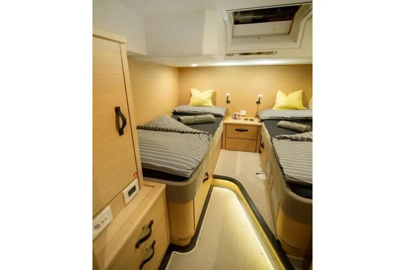  Yacht Photos Pics Luxurious 2016 Jeanneau 64 yacht cabin with twin beds and modern decor.