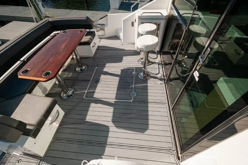 Charlotte Yacht Photos Pics Luxurious 2019 Cruisers Yachts 60 Cantius deck with seating and bar stools.