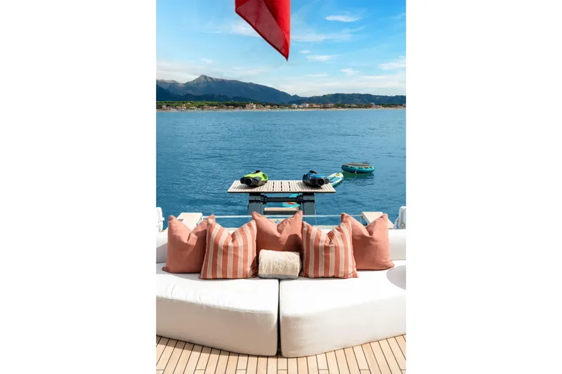 A+ Yacht Photos Pics Luxurious 2024 Benetti Oasis yacht deck with cushions, overlooking serene ocean view.