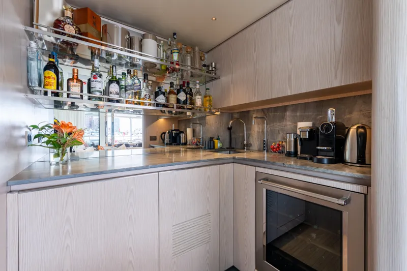 A+ Yacht Photos Pics Luxurious 2024 Benetti Oasis yacht kitchen with modern appliances and elegant bar setup.