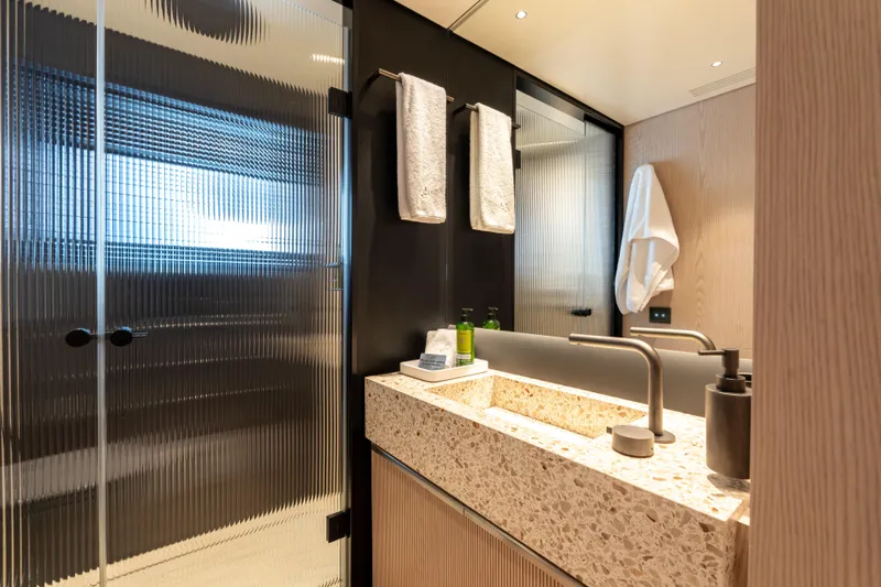 A+ Yacht Photos Pics Luxurious bathroom in 2024 Benetti Oasis yacht with modern fixtures and elegant design.