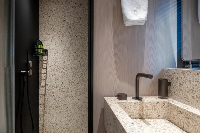 A+ Yacht Photos Pics Luxurious bathroom in 2024 Benetti Oasis yacht, featuring terrazzo sink and modern fixtures.