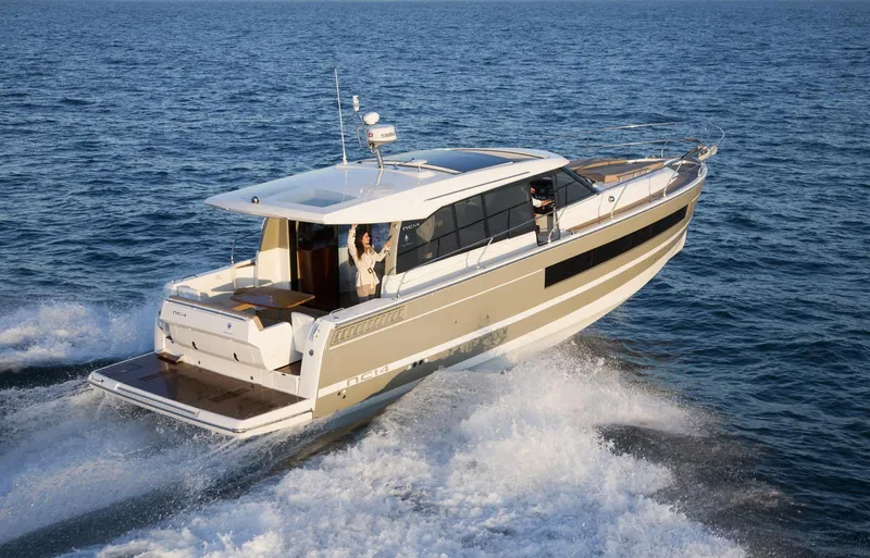  Yacht Photos Pics 2017 Jeanneau NC14 cruising on open water, showcasing sleek design and modern features.