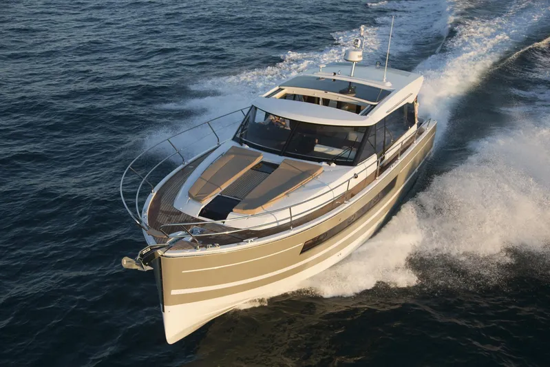  Yacht Photos Pics 2017 Jeanneau NC14 yacht cruising on open water, showcasing sleek design and performance.