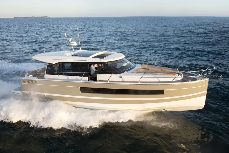  Yacht Photos Pics 2017 Jeanneau NC14 yacht cruising on open water.