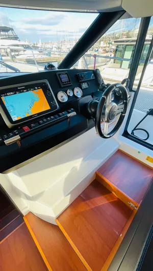 Yacht Photos Pics Interior helm of 2017 Jeanneau NC14 yacht with navigation system and steering wheel.