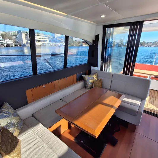  Yacht Photos Pics Interior of 2017 Jeanneau NC14 yacht with elegant seating and waterfront view.