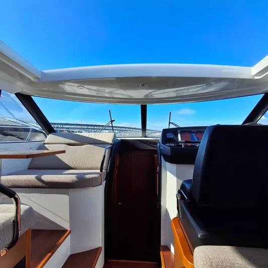  Yacht Photos Pics Interior view of 2017 Jeanneau NC14 yacht with blue sky through sunroof.