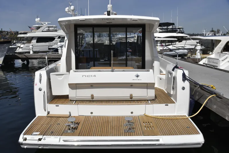  Yacht Photos Pics 2017 Jeanneau NC14 yacht docked at marina, showcasing sleek design and spacious deck.
