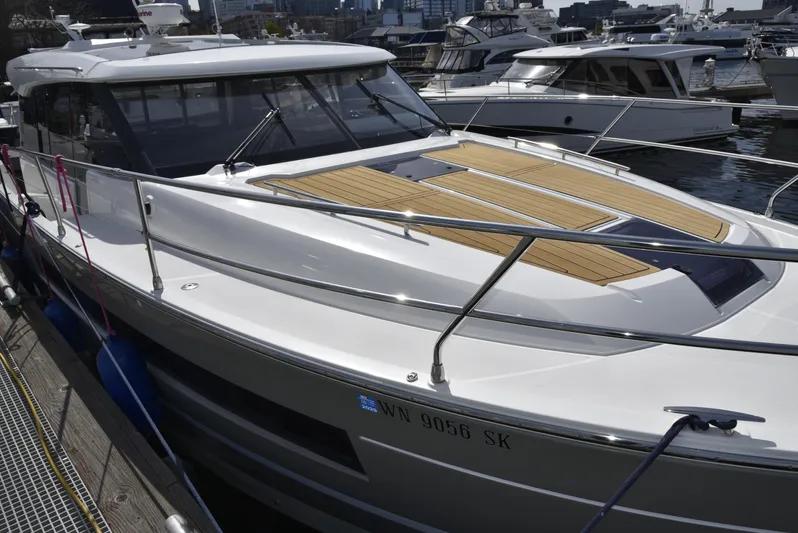  Yacht Photos Pics 2017 Jeanneau NC14 yacht docked, featuring sleek design and spacious deck.