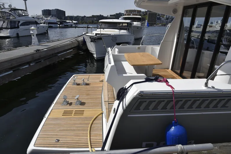  Yacht Photos Pics 2017 Jeanneau NC14 yacht docked, featuring a spacious deck and modern design.