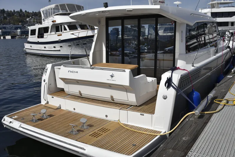  Yacht Photos Pics 2017 Jeanneau NC14 yacht docked, featuring sleek design and spacious deck.