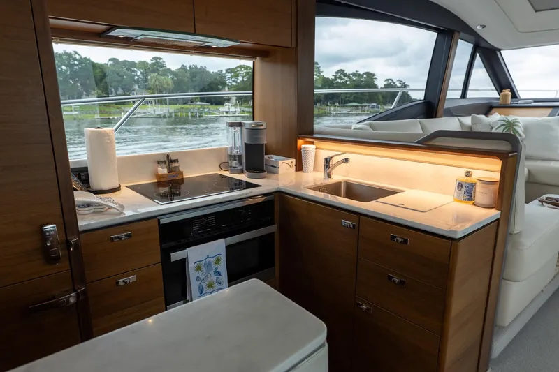 Regent Yacht Photos Pics Luxurious kitchen interior of 2021 Princess S62 yacht with modern appliances and scenic view.