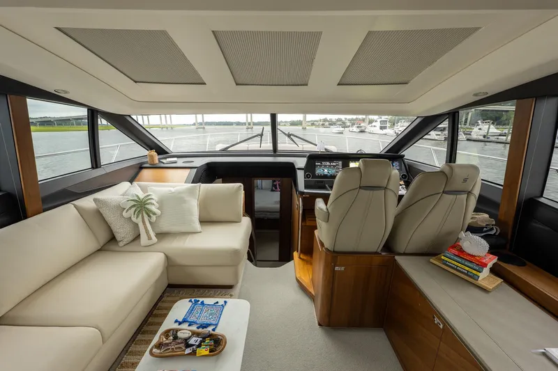 Regent Yacht Photos Pics Luxurious interior of 2021 Princess S62 yacht with modern seating and navigation area.