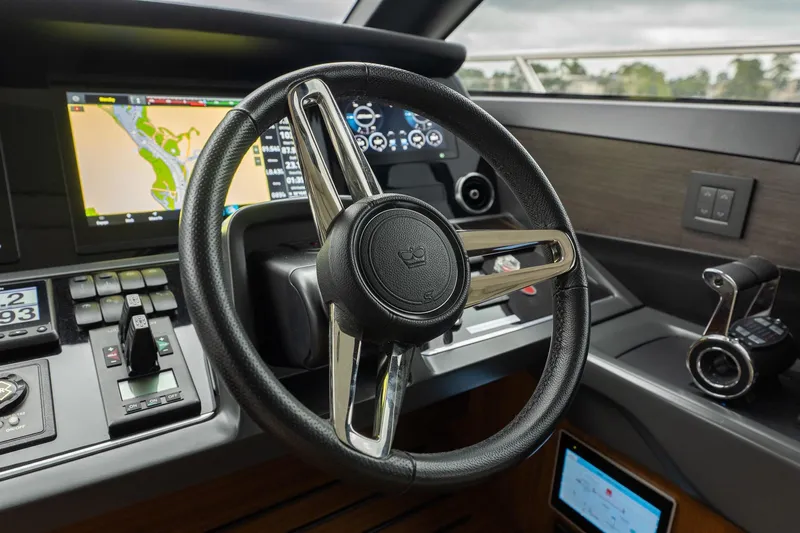 Regent Yacht Photos Pics Steering wheel and dashboard of 2021 Princess S62 yacht, featuring navigation controls.