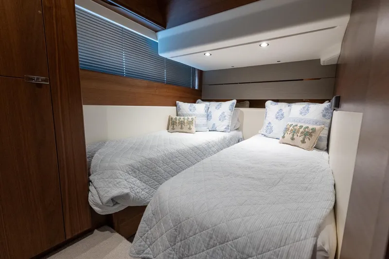 Regent Yacht Photos Pics Luxurious twin bedroom in 2021 Princess S62 yacht with elegant bedding and wood accents.