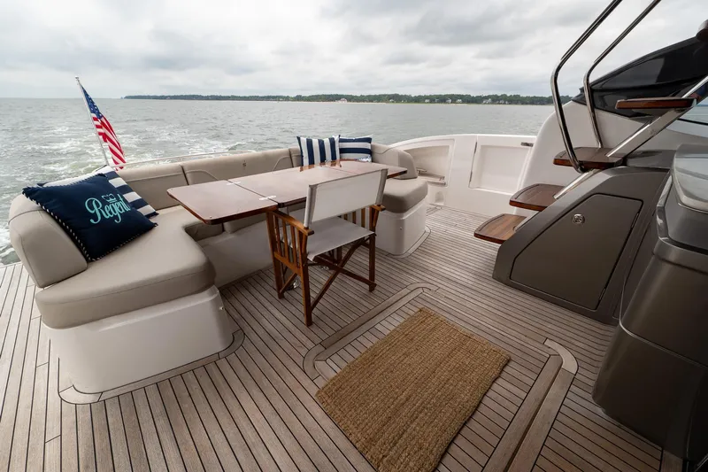 Regent Yacht Photos Pics Luxurious 2021 Princess S62 yacht deck with seating, table, and ocean view.