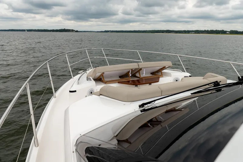 Regent Yacht Photos Pics Luxurious 2021 Princess S62 yacht with elegant deck seating on a serene waterway.