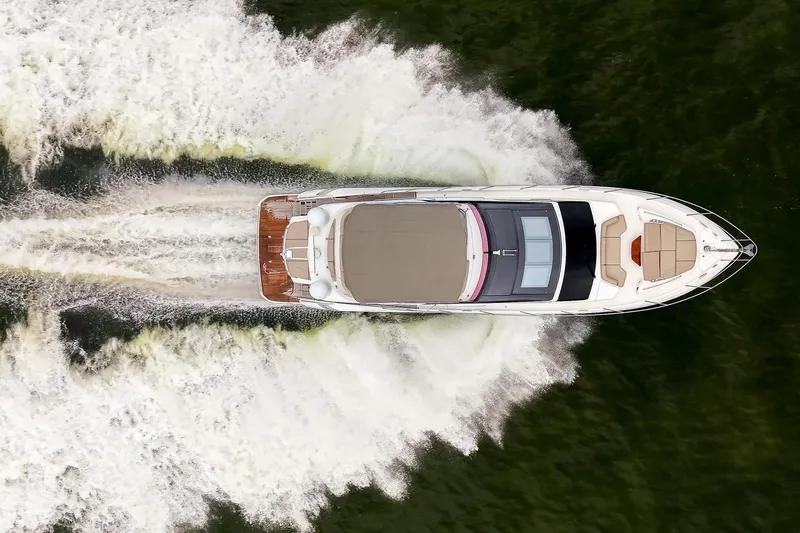 Regent Yacht Photos Pics Aerial view of 2021 Princess S62 yacht cruising on water, leaving a wake.