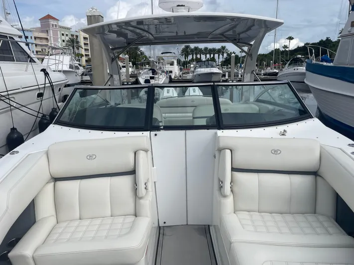  Yacht Photos Pics 2022 Cobalt 30SC boat with white seating at a marina.