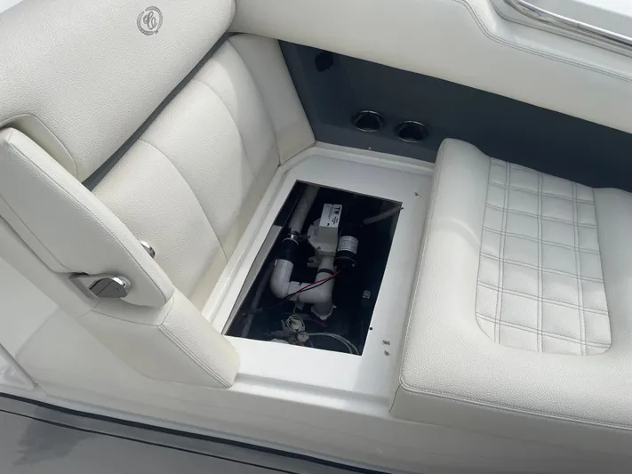  Yacht Photos Pics Cobalt 30SC 2022 boat interior with open storage compartment and white seating.