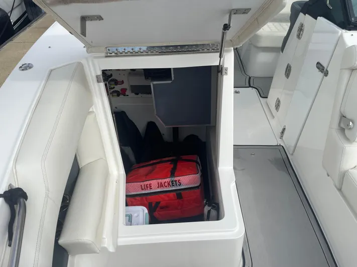  Yacht Photos Pics 2022 Cobalt 30SC boat storage compartment with life jackets.