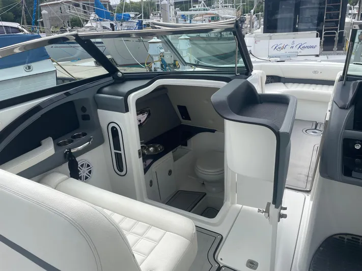 Yacht Photos Pics 2022 Cobalt 30SC boat interior with seating and helm, docked at marina.