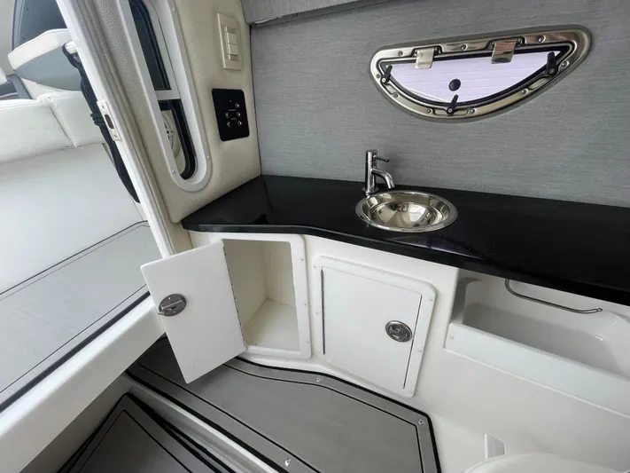 Yacht Photos Pics 2022 Cobalt 30SC boat interior with sink and storage cabinets.