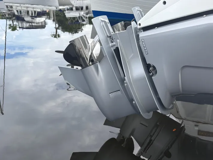  Yacht Photos Pics 2022 Cobalt 30SC boat engine reflecting on calm water surface.