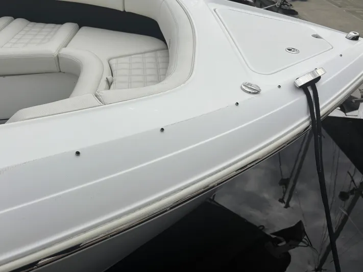  Yacht Photos Pics 2022 Cobalt 30SC boat with sleek white exterior and cushioned seating.