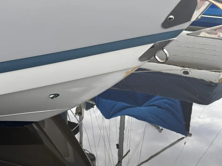  Yacht Photos Pics Close-up of 2022 Cobalt 30SC boat hull with water reflection.