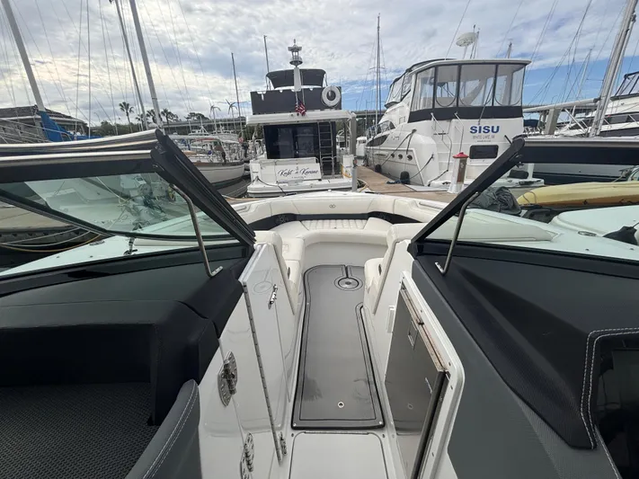  Yacht Photos Pics 2022 Cobalt 30SC boat interior at marina, surrounded by other boats.