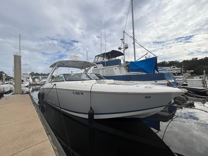  Yacht Photos Pics 2022 Cobalt 30SC boat docked at marina under cloudy sky.