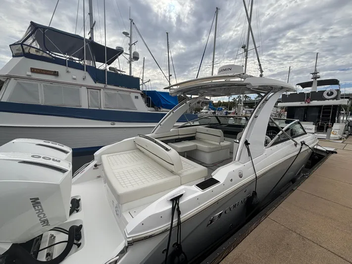  Yacht Photos Pics 2022 Cobalt 30SC boat docked, featuring spacious seating and Mercury engine.