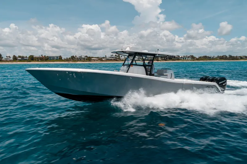  Yacht Photos Pics 2020 Invincible 39 Open Fisherman boat cruising on blue ocean waters.
