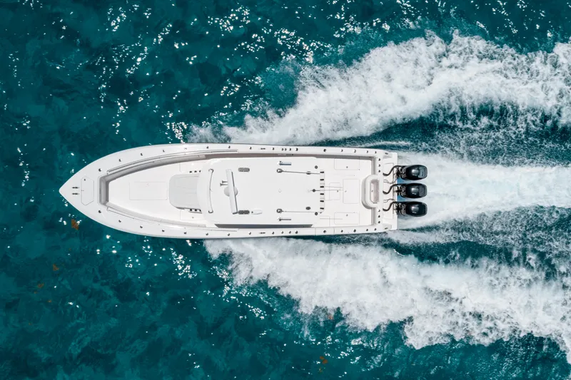  Yacht Photos Pics 2020 Invincible 39 Open Fisherman boat cruising on clear blue water, aerial view.