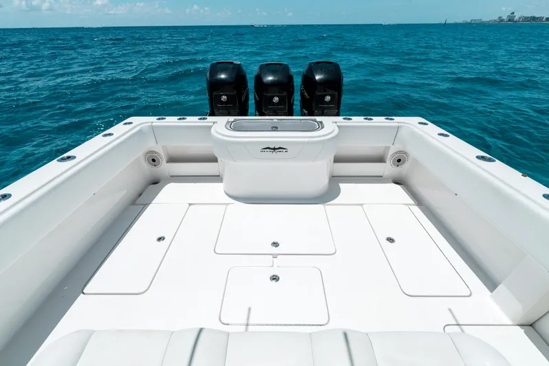  Yacht Photos Pics 2020 Invincible 39 Open Fisherman boat with triple engines on open ocean.