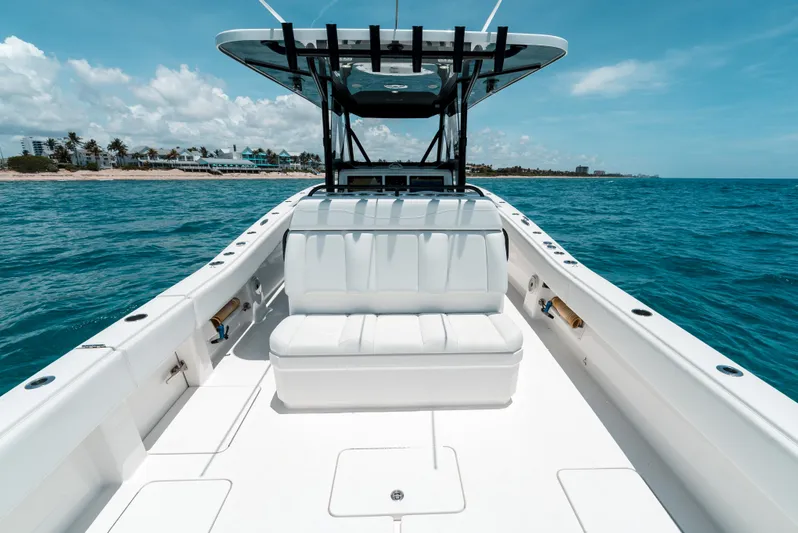  Yacht Photos Pics 2020 Invincible 39 Open Fisherman boat on clear blue ocean near coastline.