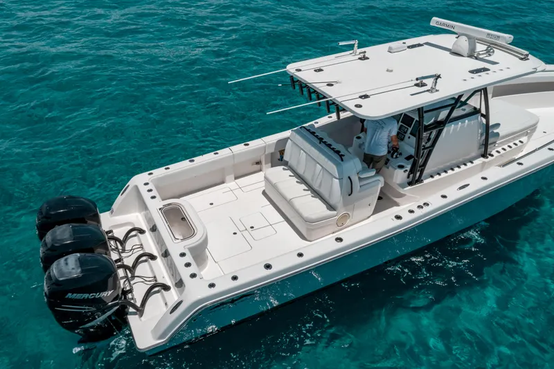  Yacht Photos Pics 2020 Invincible 39 Open Fisherman boat on clear blue water, featuring triple Mercury engines.