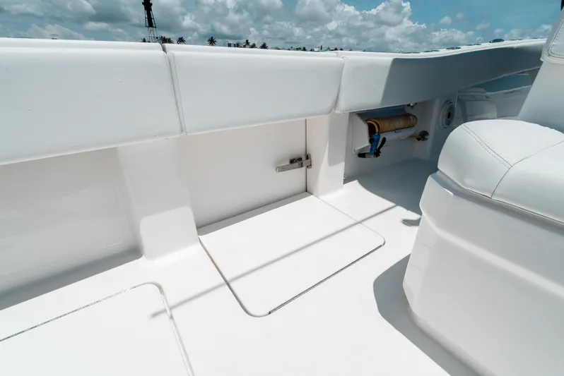  Yacht Photos Pics 2020 Invincible 39 Open Fisherman boat interior with white seating and storage compartment.