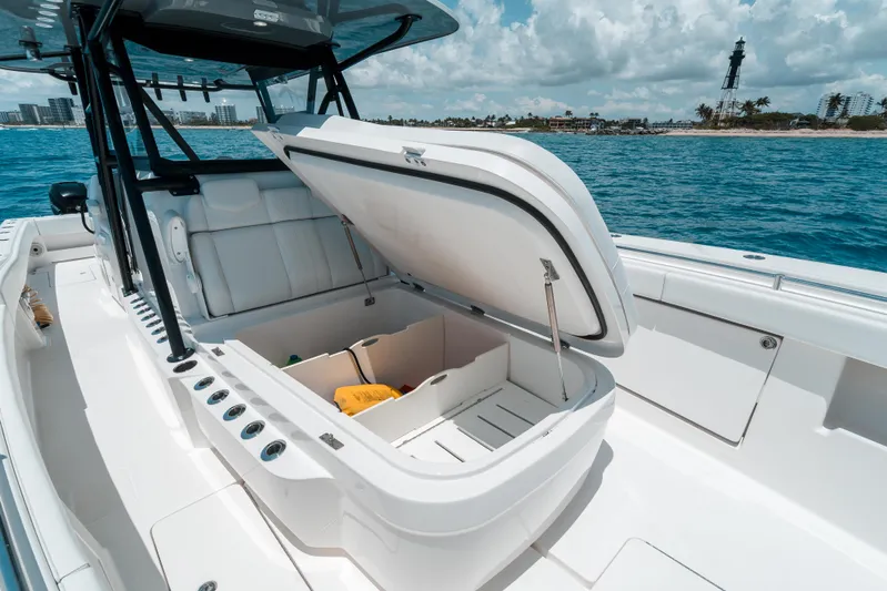  Yacht Photos Pics 2020 Invincible 39 Open Fisherman boat with open storage compartment, ocean and lighthouse in background.