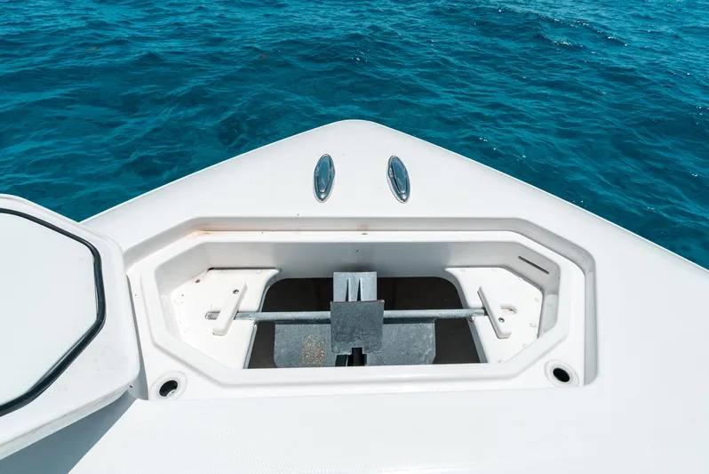  Yacht Photos Pics Bow of 2020 Invincible 39 Open Fisherman boat with anchor compartment, on blue ocean water.